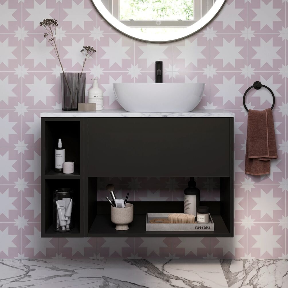 Lifestyle image of the Britton Hackney Matt Black 800mm Wall Hung Vanity Unit with Carrara Worktop & Shelf Unit with countertop basin, tap, towel ring and bathroom items store within shelving